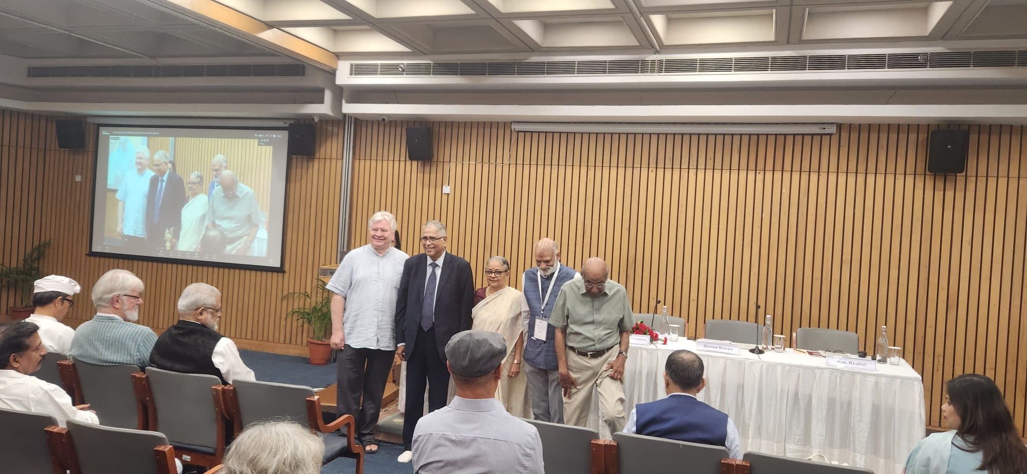 Dominik Wujastyk, Dr Sudha Gopalakrishnan and guests standing before the platform after the lamp-lighting